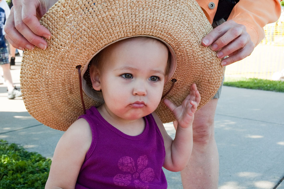 Little Girl Wearing A Big Hat